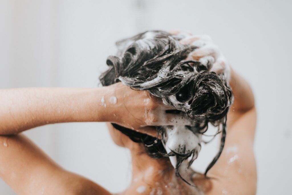 woman washing her hair in the shower