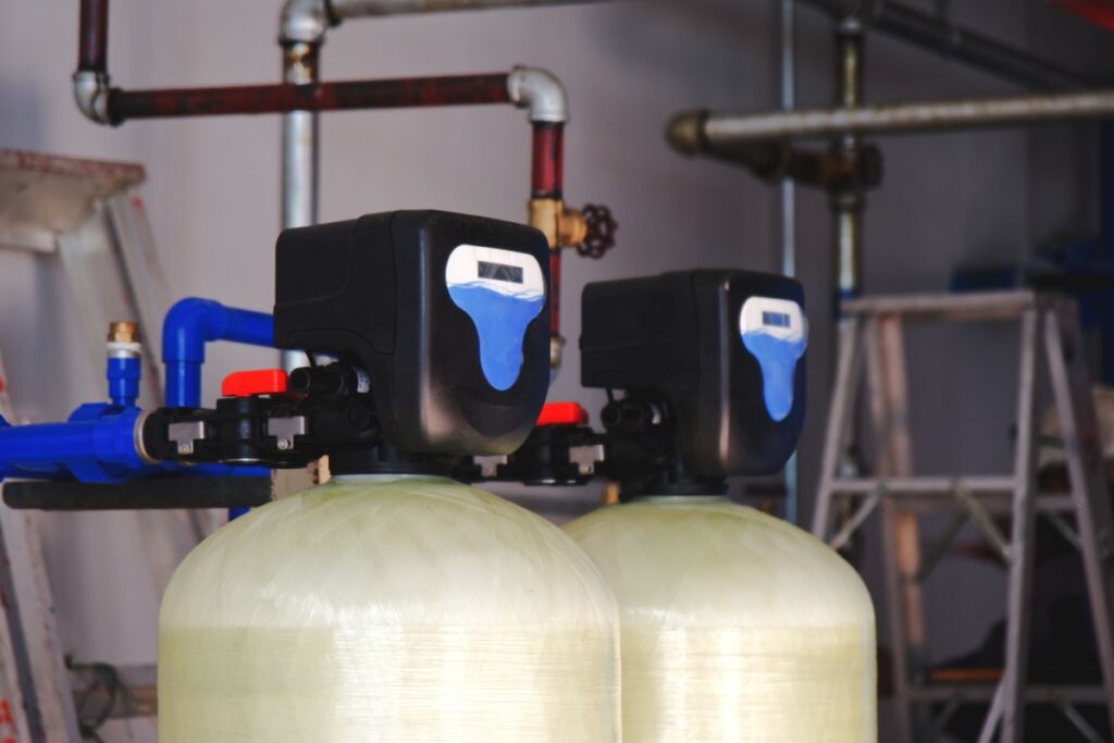 a water softener and filtration system installed in a residential garage - the valve head is visible to show the bypass valve