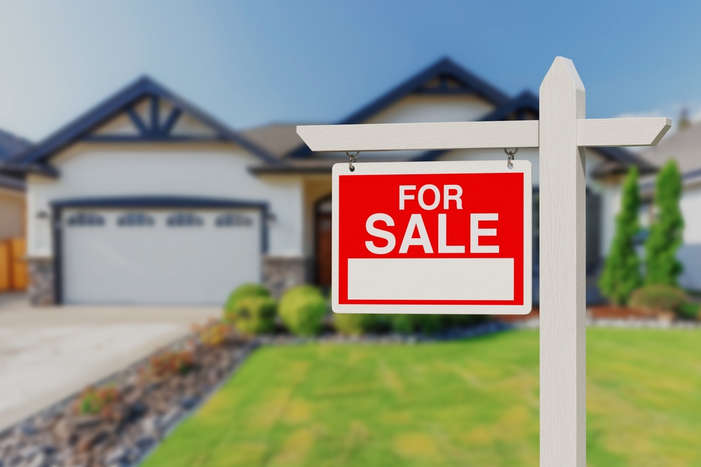 for sale sign in front of a house that has a water treatment system